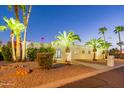 Luxury home with palm trees and beautiful landscaping at night at 4639 E Mountain View Ct, Phoenix, AZ 85028