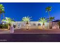 Stunning desert home with palm trees and beautiful landscaping at night at 4639 E Mountain View Ct, Phoenix, AZ 85028