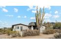 Front view of a ranch style house with a large saguaro cactus at 5428 E El Sendero Dr, Cave Creek, AZ 85331