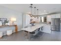 Contemporary kitchen with stainless steel appliances and sleek dining area at 6990 E 6Th St # 1005, Scottsdale, AZ 85251
