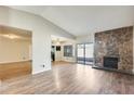 Living room boasts a stone fireplace and wood-look flooring at 7010 W Medlock Dr, Glendale, AZ 85303