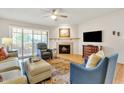 Living room with fireplace, large TV, and ample seating at 7950 E Starlight Way # 220, Scottsdale, AZ 85250