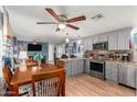 Modern kitchen with gray cabinets, stainless steel appliances and breakfast bar at 9333 E University Dr # 55, Mesa, AZ 85207