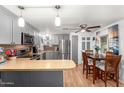 Modern kitchen with gray cabinets, stainless steel appliances and breakfast bar at 9333 E University Dr # 55, Mesa, AZ 85207