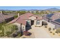 Single-story home with tile roof and solar panels; mountain views at 9514 E Cavalry Dr, Scottsdale, AZ 85262