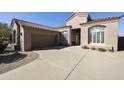 One-story home with tile roof, attached garage, and desert landscaping at 9514 E Cavalry Dr, Scottsdale, AZ 85262