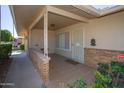 Covered entryway with brickwork, security door, and tiled floor at 9614 N 110Th Ave, Sun City, AZ 85351