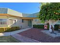 Front entrance with a decorative security door and landscaping at 10529 W Pineaire Dr, Sun City, AZ 85351