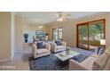 Bright living room with comfortable seating and access to a patio at 10529 W Pineaire Dr, Sun City, AZ 85351