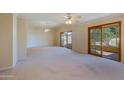 Open living space with large windows and access to a patio at 10529 W Pineaire Dr, Sun City, AZ 85351