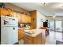 Cozy kitchen with oak cabinets, island, and access to backyard at 11596 W Sierra Dawn Blvd # 134, Surprise, AZ 85378
