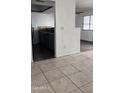 View of kitchen with gray cabinets and tile flooring from dining area at 18202 N Cave Creek Rd # 128, Phoenix, AZ 85032