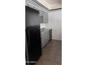 Gray cabinets and black appliances in this updated kitchen at 18202 N Cave Creek Rd # 128, Phoenix, AZ 85032
