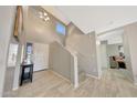Bright and spacious entryway with tiled floors and staircase at 1976 S 172Nd Ln, Goodyear, AZ 85338