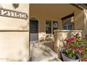 Inviting house exterior with a covered porch, landscaped flower bed, and a security door at 21150 W Prospector Way, Buckeye, AZ 85396