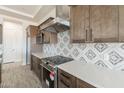 Contemporary kitchen featuring stainless steel appliances, wooden cabinets, and white quartz countertops at 24235 N 194Th Ave, Surprise, AZ 85387
