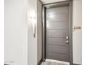 Modern apartment entry with gray door and sleek light fixture at 5250 E Deer Valley Dr # 450, Phoenix, AZ 85054