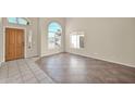 Bright Foyer featuring tiled flooring, high ceilings, and large arched windows at 659 S Dodge St, Gilbert, AZ 85233