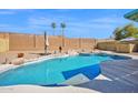 Inviting pool area featuring rock waterfall features, lush landscaping, and a spacious patio, creating a peaceful oasis at 659 S Dodge St, Gilbert, AZ 85233