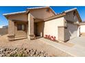 Front view of the house, showing the entrance and landscaping at 1102 N 5Th St, Buckeye, AZ 85326