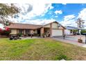 Attractive single-story home with landscaped front yard and attached garage at 1449 W Mohawk Ln, Phoenix, AZ 85027