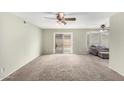 Spacious living room featuring neutral carpeting and access to a patio at 1449 W Mohawk Ln, Phoenix, AZ 85027