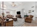 Spacious living room with tiled floors and comfortable furniture at 18208 W Skyline Dr, Surprise, AZ 85374