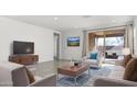 Bright living room with sliding doors leading to a patio at 2033 W Burnside Trl, Phoenix, AZ 85085