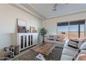 Living room features a neutral palette and sliding glass doors to backyard at 24271 N 194Th Ave, Surprise, AZ 85387