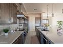 Bright, modern kitchen boasts stainless steel appliances, sleek countertops, and designer finishes for a chef-inspired space at 24301 N 194Th Ave, Surprise, AZ 85387