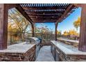 Outdoor kitchen with granite countertops and built-in grill under a pergola at 2838 E Shady Spring Trl, Phoenix, AZ 85024