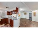 Kitchen features wood cabinets and laminate flooring at 305 S Val Vista Dr # 417, Mesa, AZ 85204
