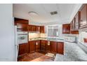 Galley kitchen with ample wood cabinets at 305 S Val Vista Dr # 417, Mesa, AZ 85204