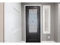 Front entry with an ornate door and sidelight window at 31310 N 26Th Dr, Phoenix, AZ 85085