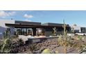 Stylish backyard with desert landscaping, a modern fire pit, and comfortable seating at 42418 N Sierra Vista 1 Dr, Cave Creek, AZ 85331