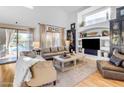 Living room with hardwood floors, high ceilings, built-ins, and pool view at 4529 E Coyote Wash Dr, Cave Creek, AZ 85331
