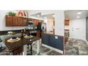 Granite kitchen island with breakfast bar seating and ample cabinetry at 5228 N 15Th Dr, Phoenix, AZ 85015