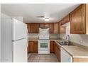 Bright kitchen featuring wood cabinets and white appliances at 5397 N Black Cyn Hwy, Phoenix, AZ 85015