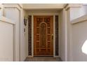 Ornate wood front door with decorative carvings and glass sidelights at 6945 E Glenrosa Ave, Scottsdale, AZ 85251