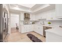 Modern white kitchen with stainless steel appliances and quartz countertops at 6945 E Glenrosa Ave, Scottsdale, AZ 85251