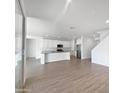 Modern kitchen with white cabinets, stainless steel appliances, and an island at 703 W Magena Dr, San Tan Valley, AZ 85140