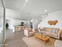 Open living room featuring neutral colors, modern furniture, and kitchen view at 703 W Magena Dr, San Tan Valley, AZ 85140