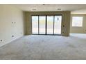 Spacious living room featuring a large sliding glass door with stunning views of the natural environment at 7638 W Rowel Rd, Peoria, AZ 85383
