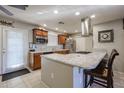 Island kitchen with granite countertops and stainless steel appliances at 10223 W Clair Dr, Sun City, AZ 85351