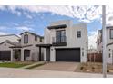 Contemporary two-story house with a dark garage door and walkway at 10249 E Ulysses Ave, Mesa, AZ 85212