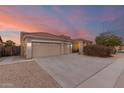 Two-story house with a three car garage and desert landscaping at 10310 E Posada Ave, Mesa, AZ 85212
