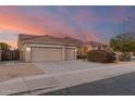 Two-story house with a three car garage and desert landscaping at 10310 E Posada Ave, Mesa, AZ 85212