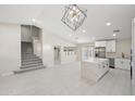 Modern kitchen with white cabinets, a large island, and stainless steel appliances at 15040 W Polk St, Goodyear, AZ 85338