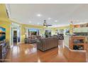Spacious living room with hardwood floors and access to backyard at 15938 W Summerwalk Dr, Surprise, AZ 85374