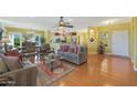 Bright living room featuring hardwood floors and comfortable seating at 15938 W Summerwalk Dr, Surprise, AZ 85374